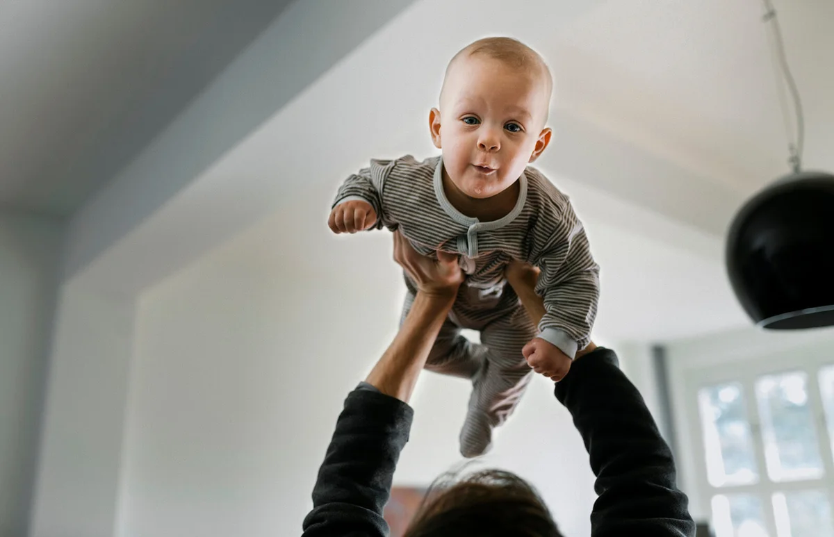 Father lifting baby son