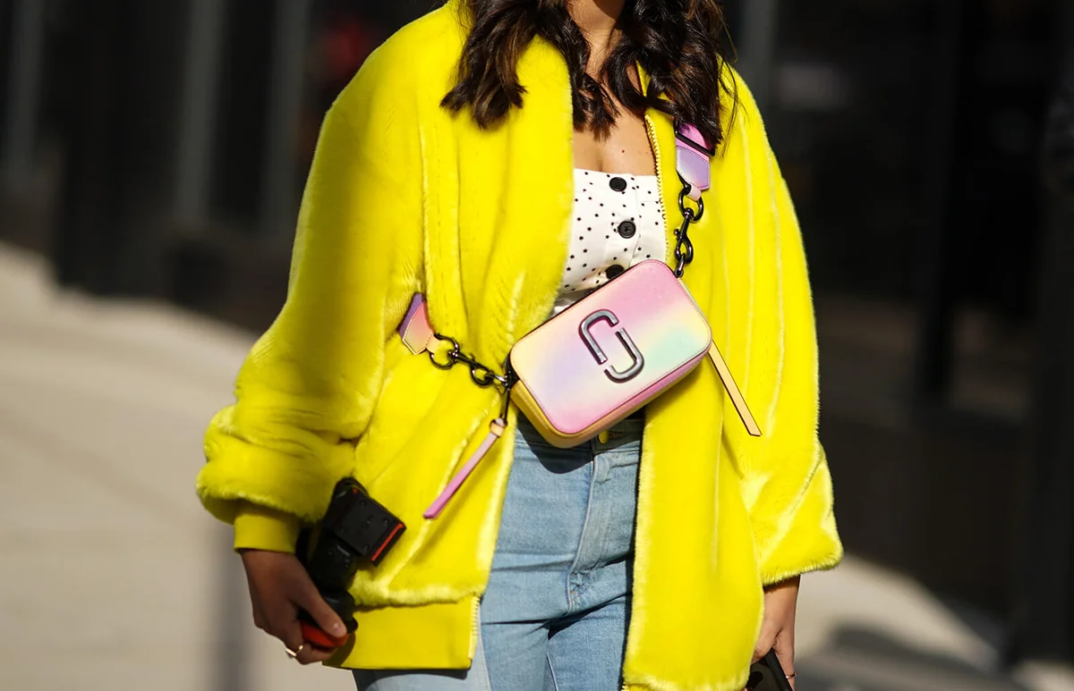 A guest wears a yellow fluffy coat, a pink Chloe bag, outside Brock Collection, during New York Fashion Week Fall Winter 2020 | Getty Editorial Use