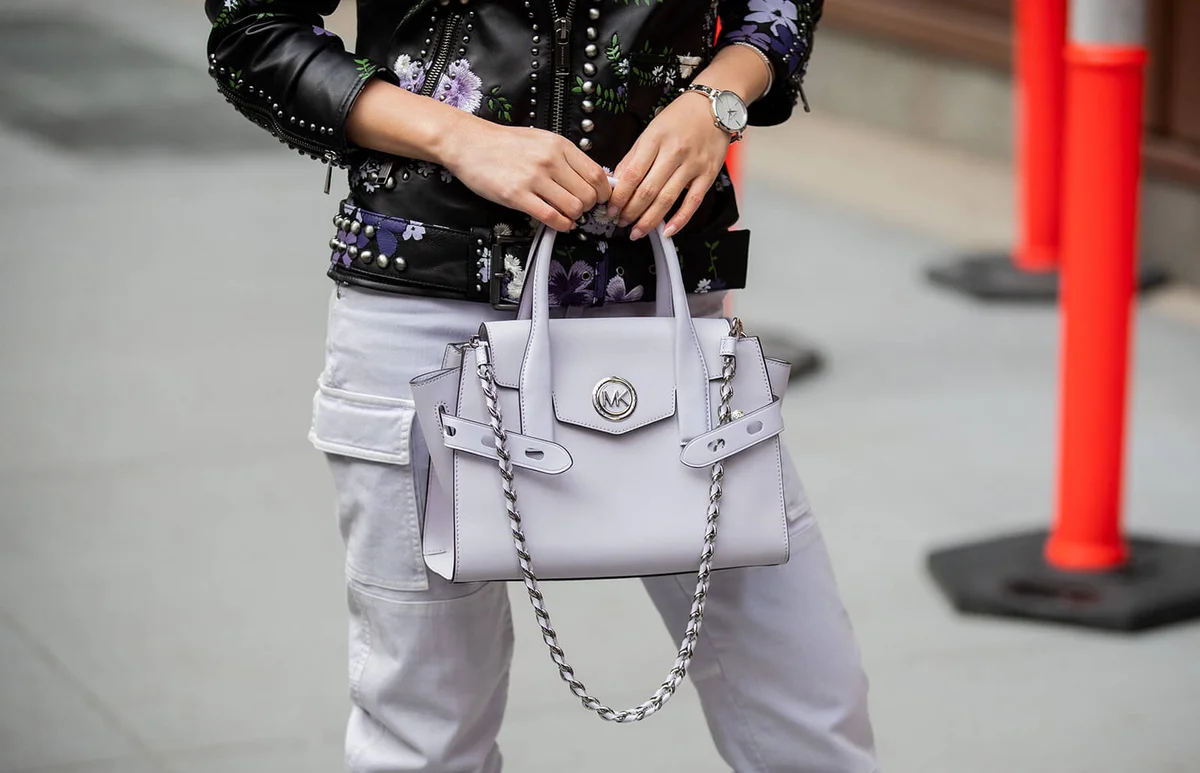 Jessica Wang is seen wearing bag, leather jacket with floral print, pants outside Michael Kors during New York Fashion Week Fall / Winter 2020 | Getty Editorial Use