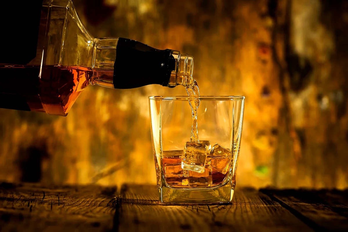 Barman pouring rum