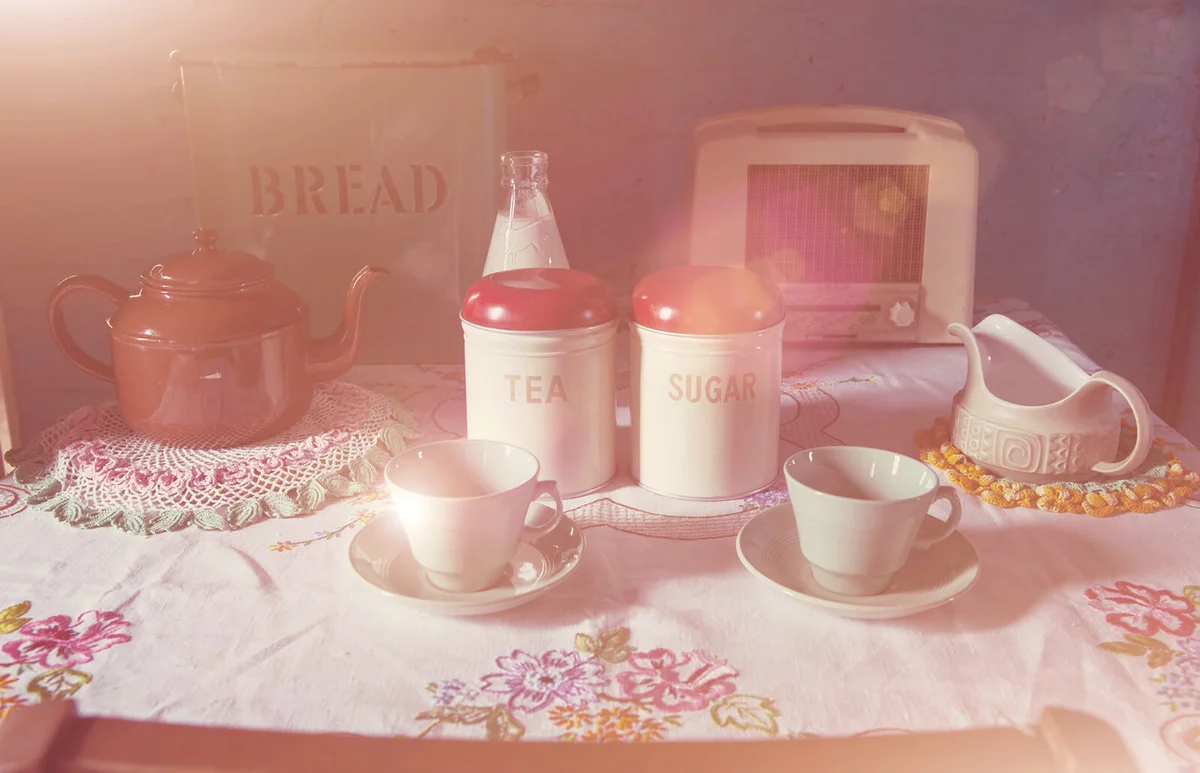 Sun shining over table with tea pot and cups