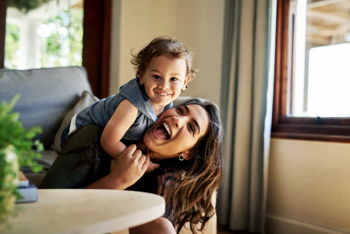 Affectionate young mother spending time with her little son