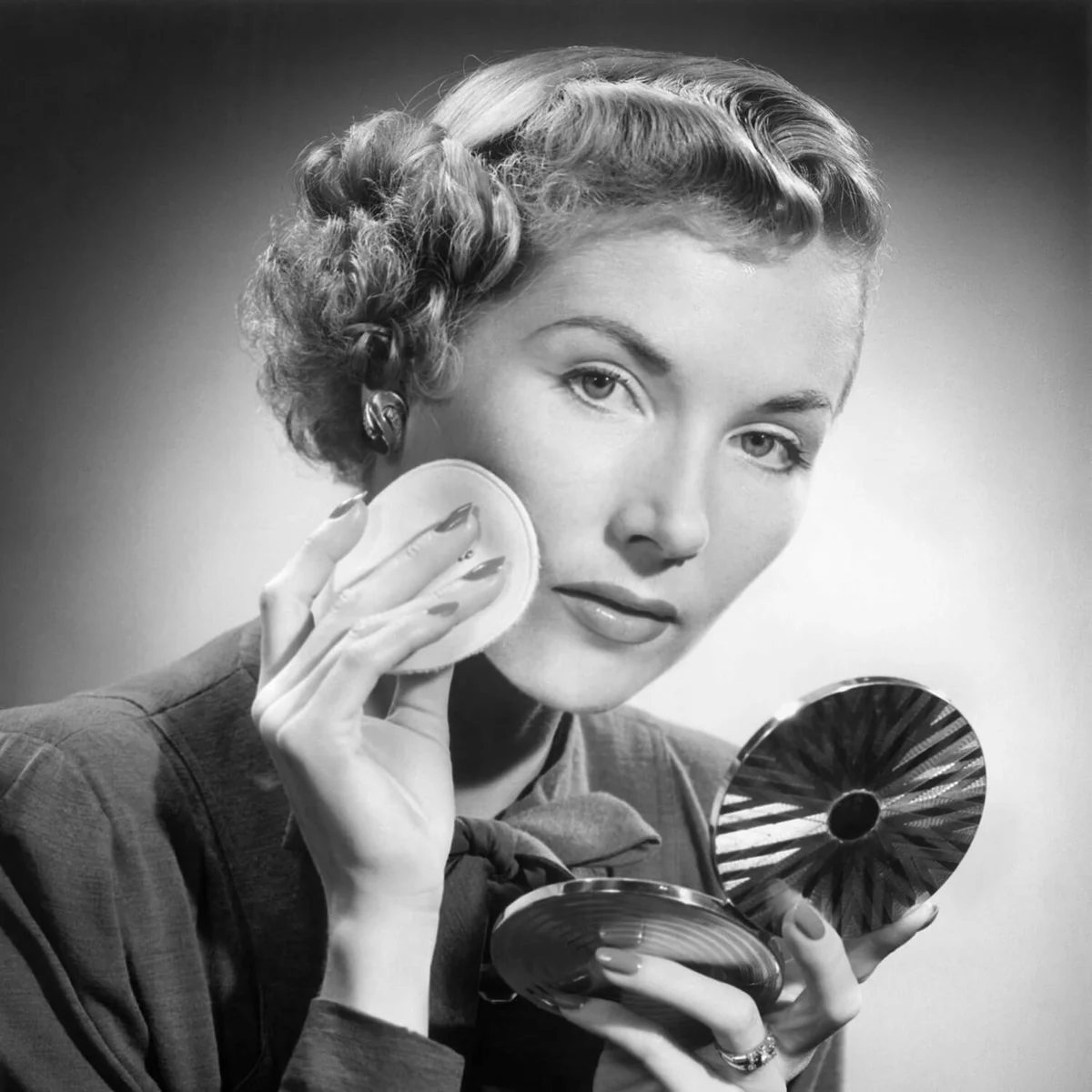 Woman powdering her face