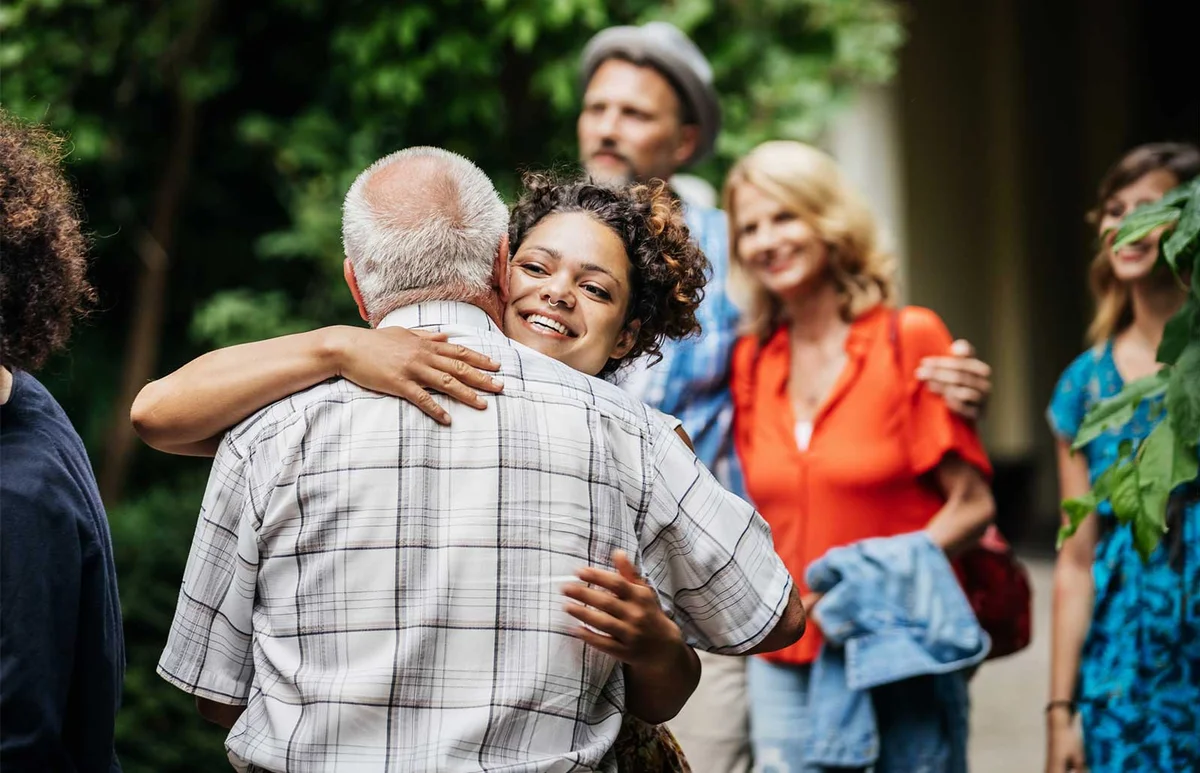 woman hugging elderly man at end of life celebration