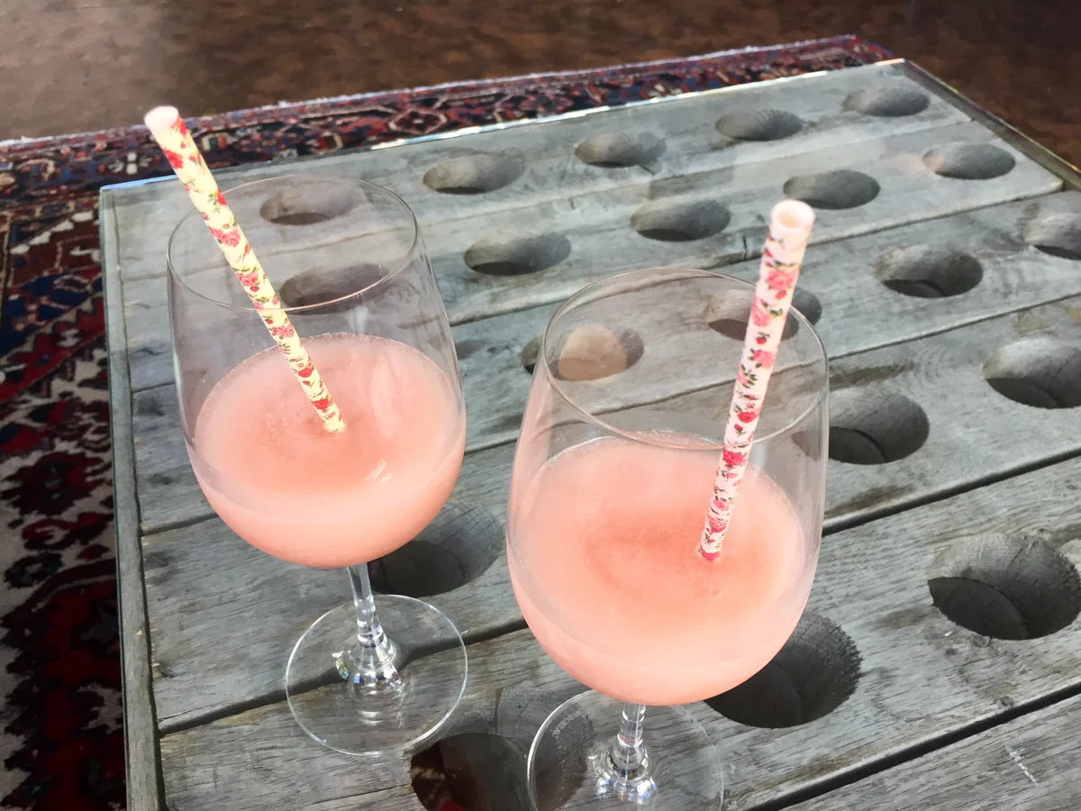 Pink sherbet punch in goblets with straws