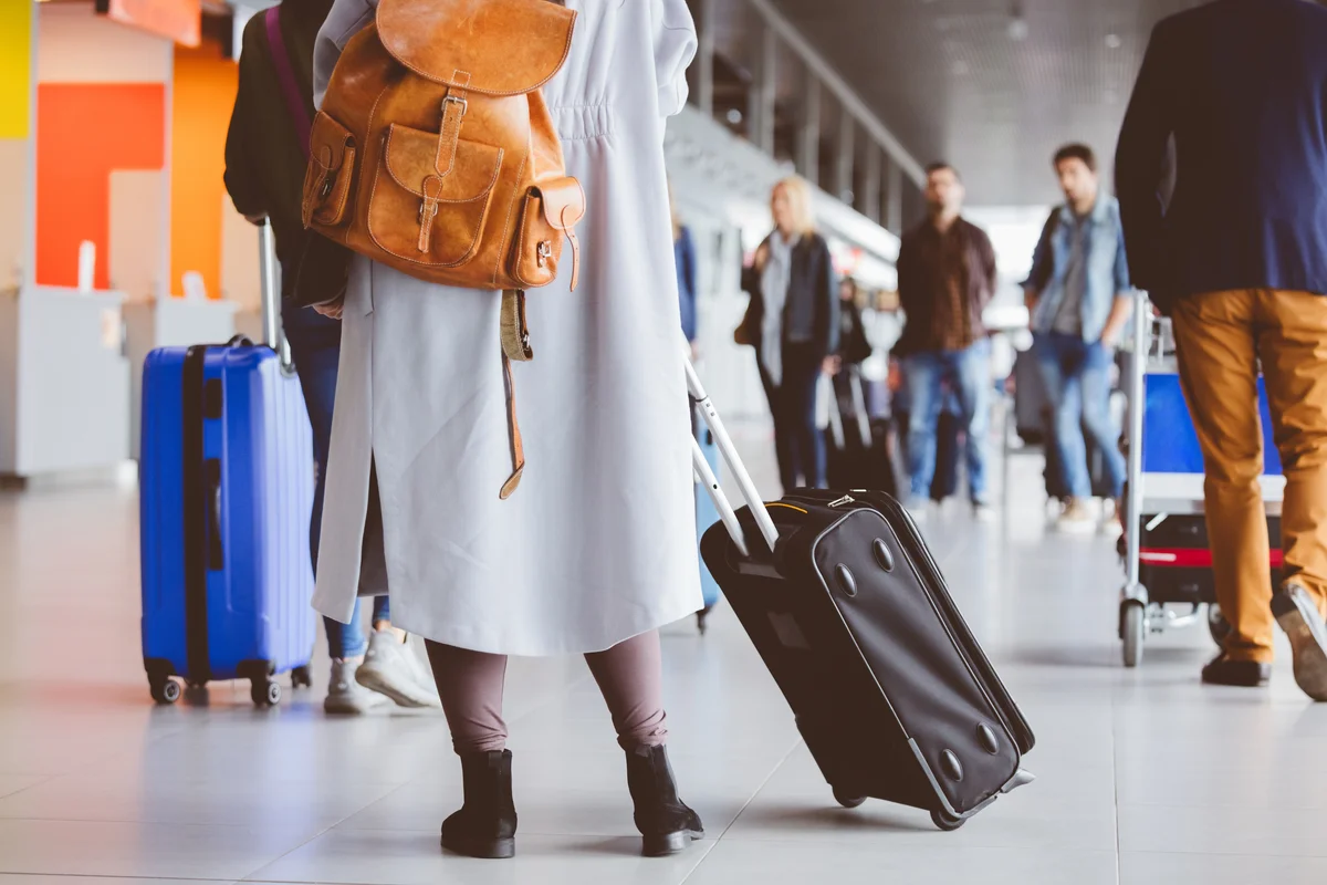 Woman traveling with cremation urn in handbag at airport