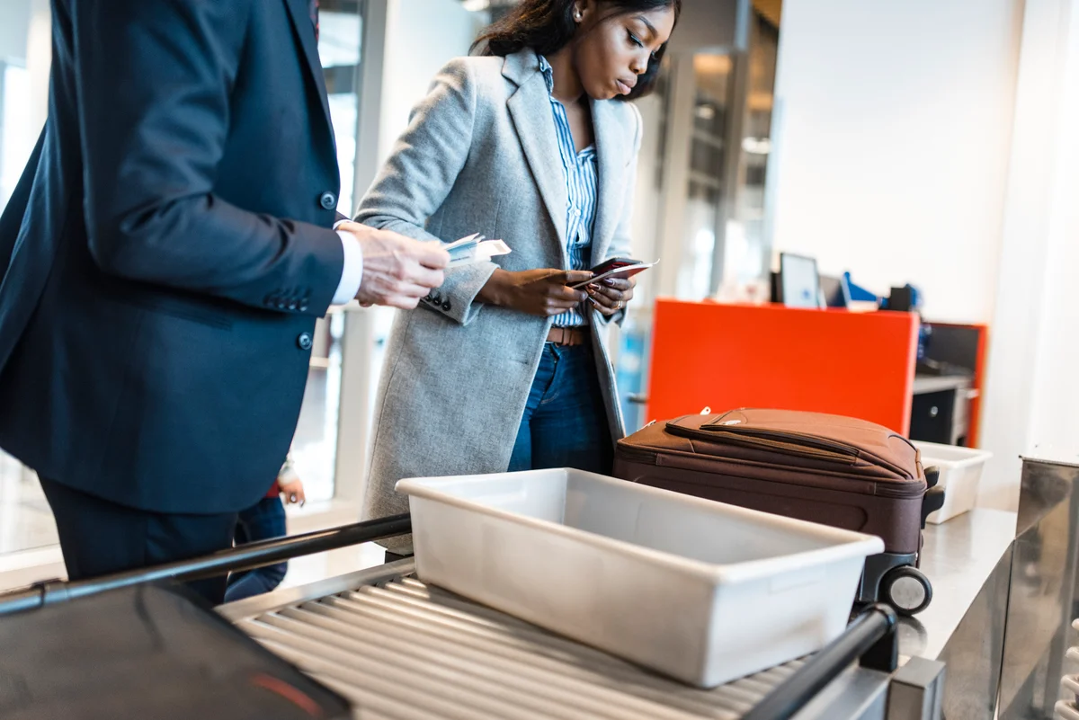 Passengers going through airport scanner and security