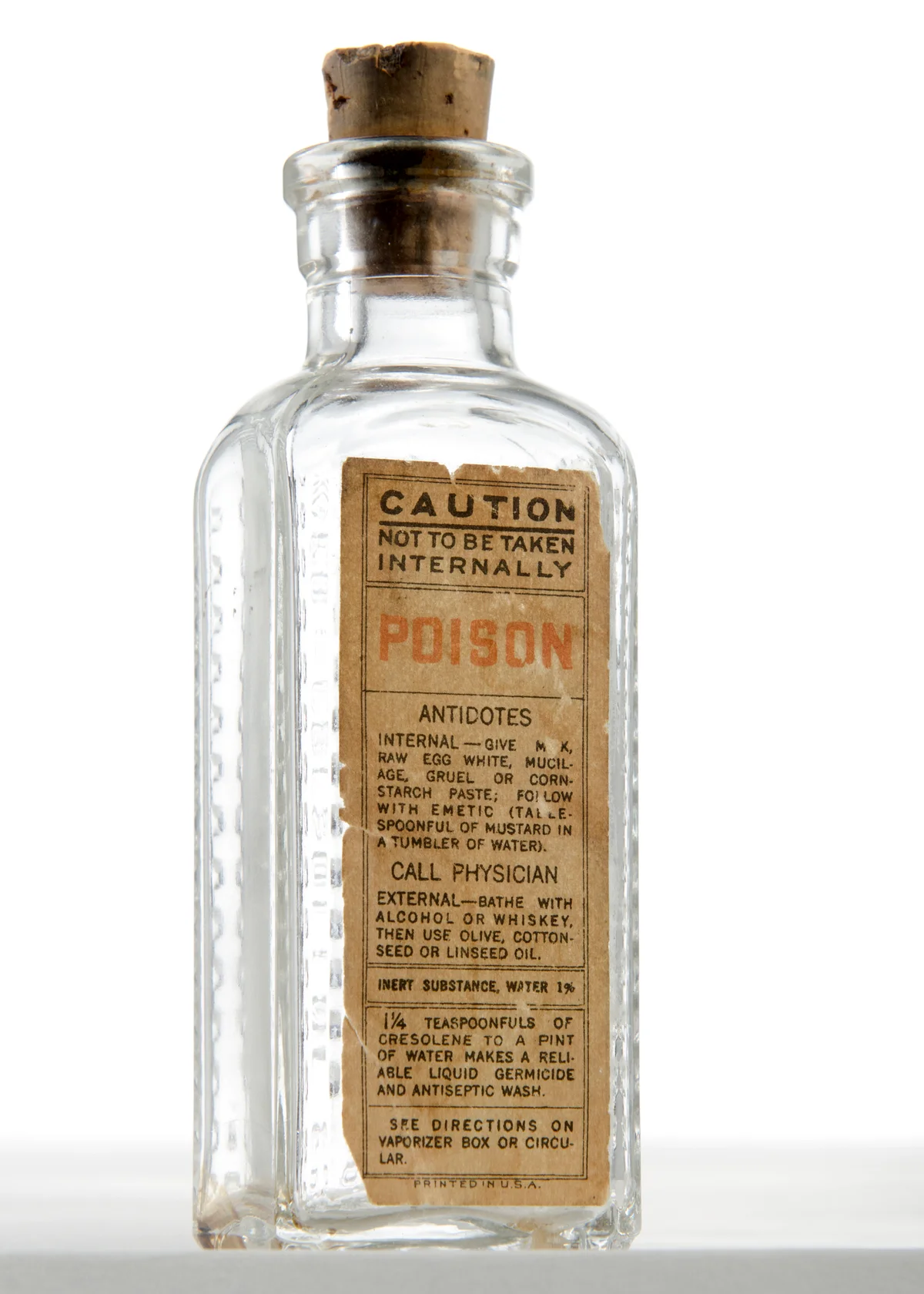 Antique poison bottle with cork shaped like medicine bottle