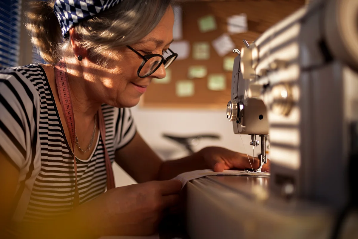 Woman working at the sewing machine at home