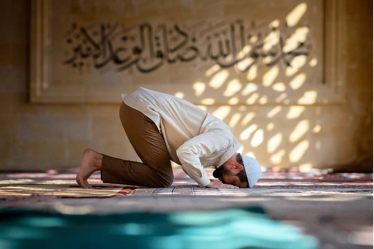 Muslim man is praying in mosque