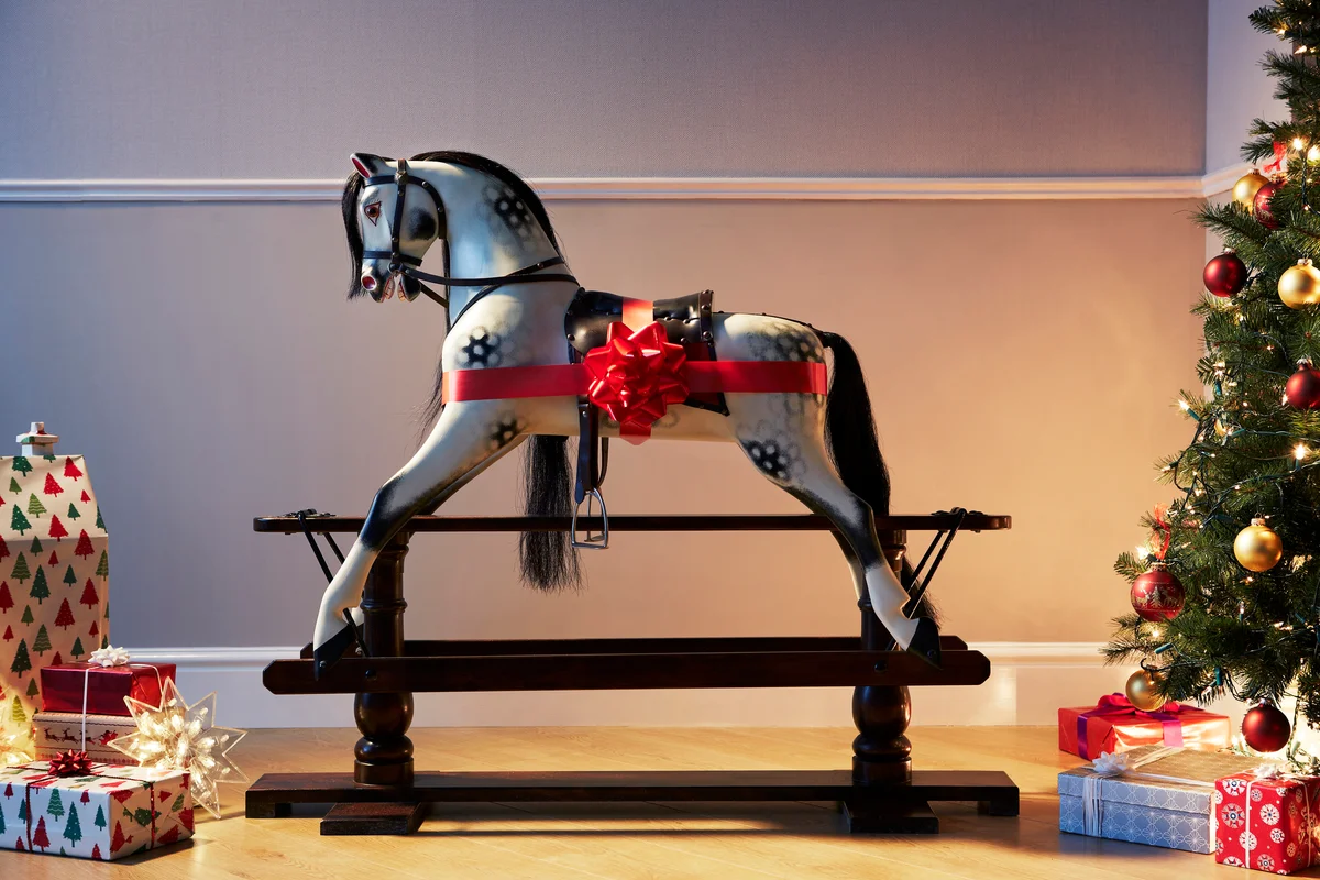 Rocking horse with large bow and christmas present