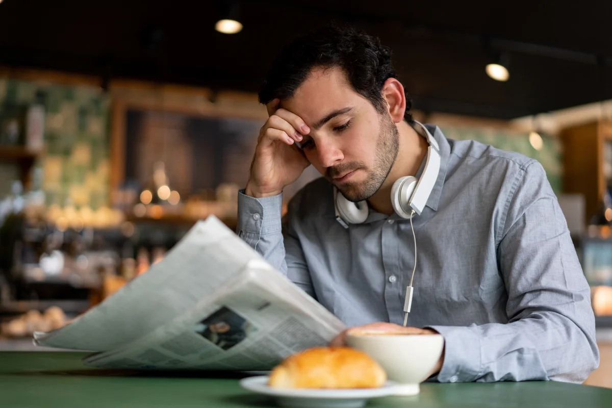 Man reading obituary