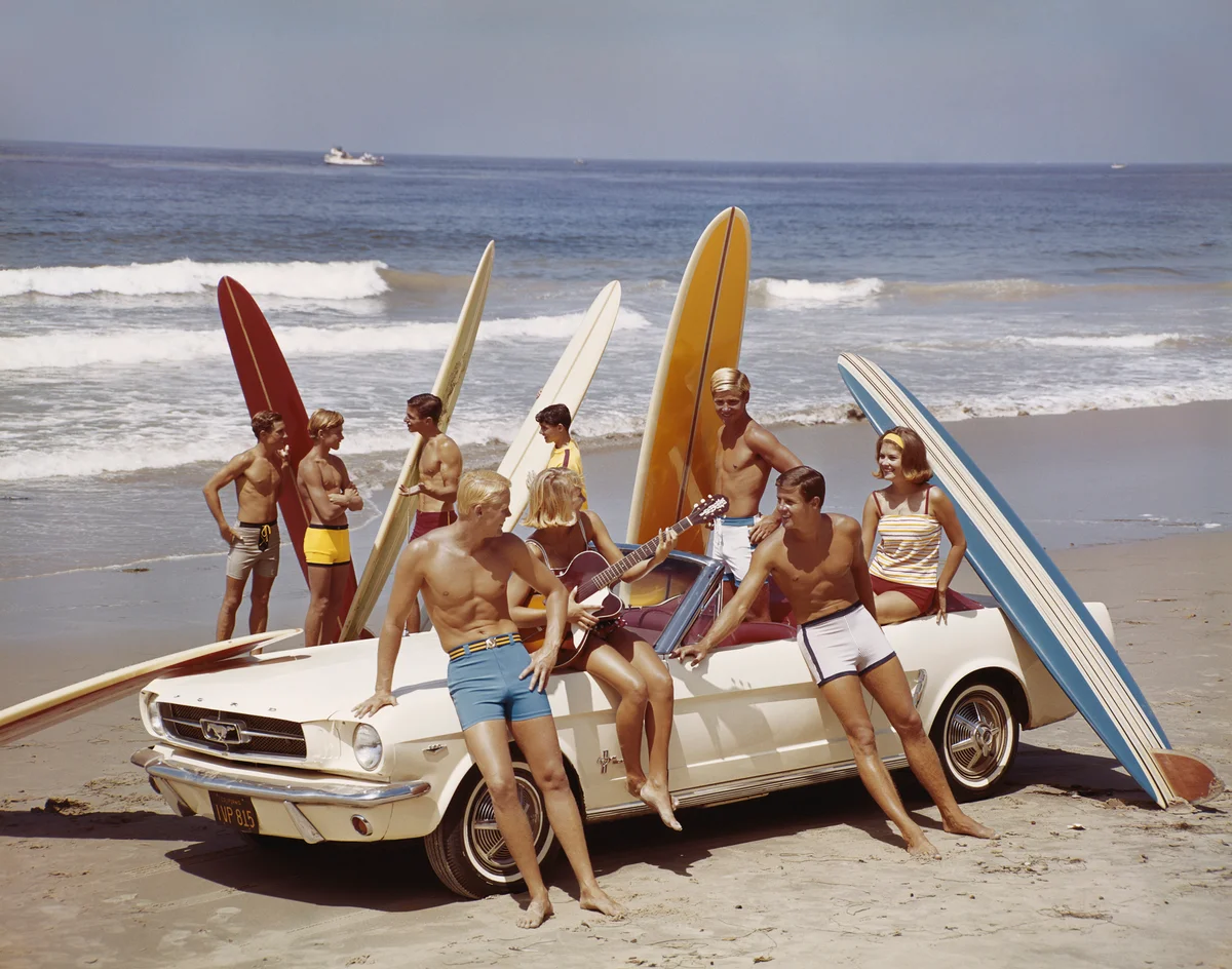 Retro art scene of friends with surfboards on the beach beach
