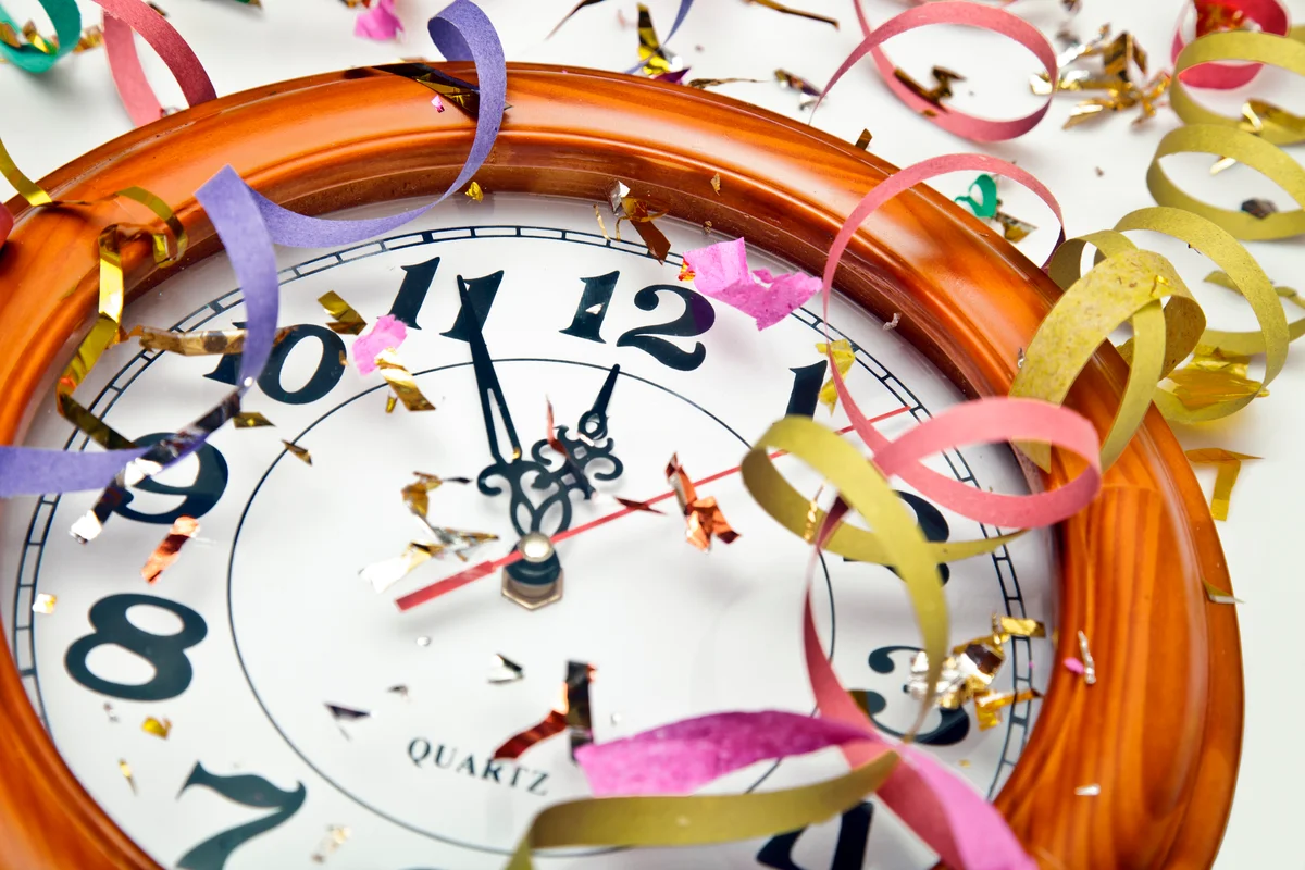 Clock covered with confetti and ribbons