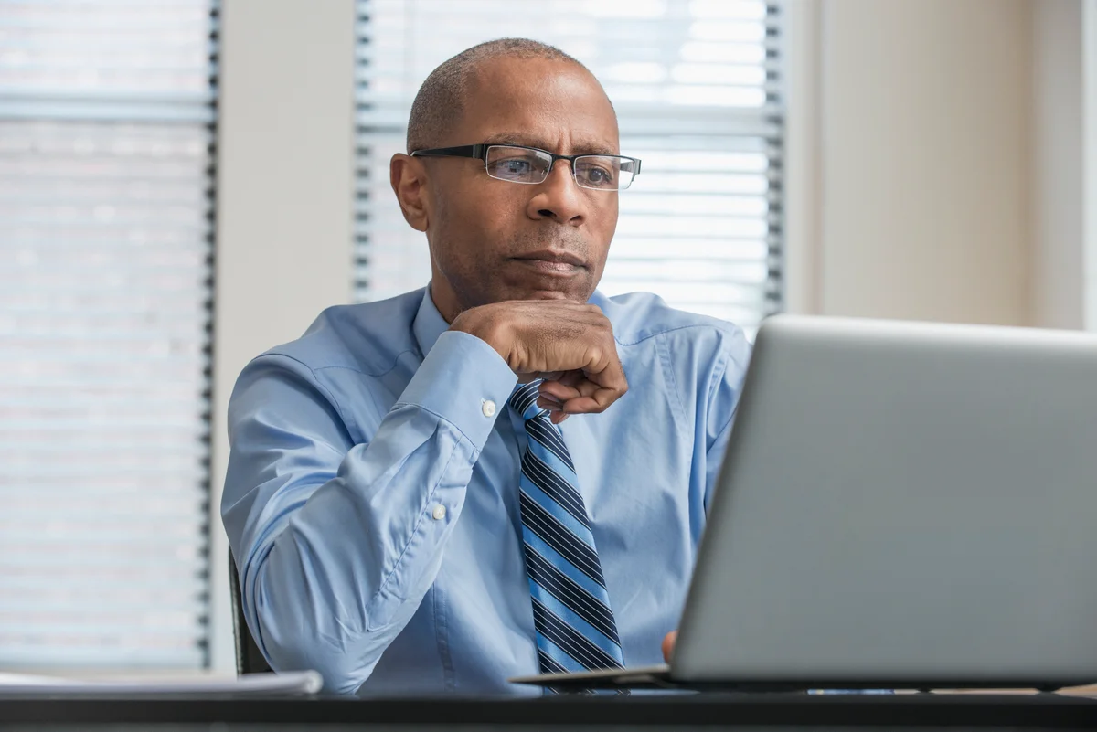 Man with pensive look working on laptop