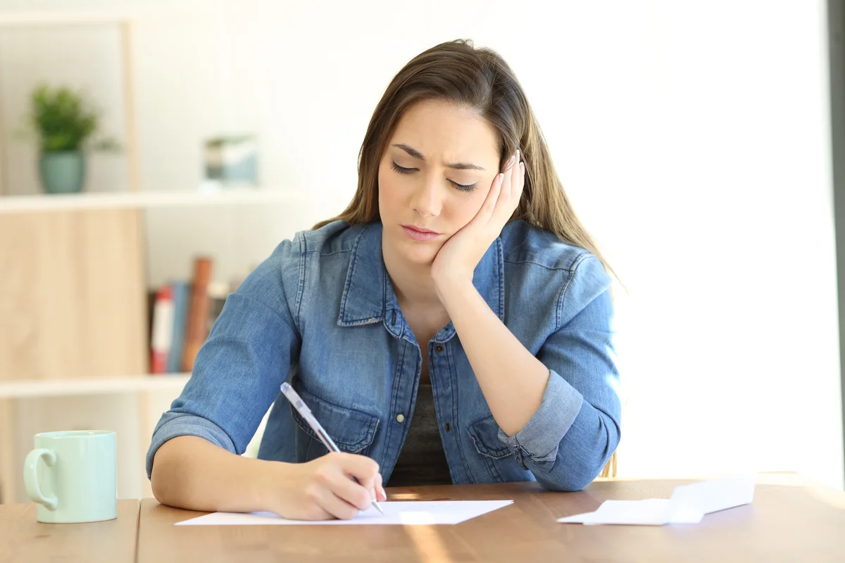 Sad woman writing letter