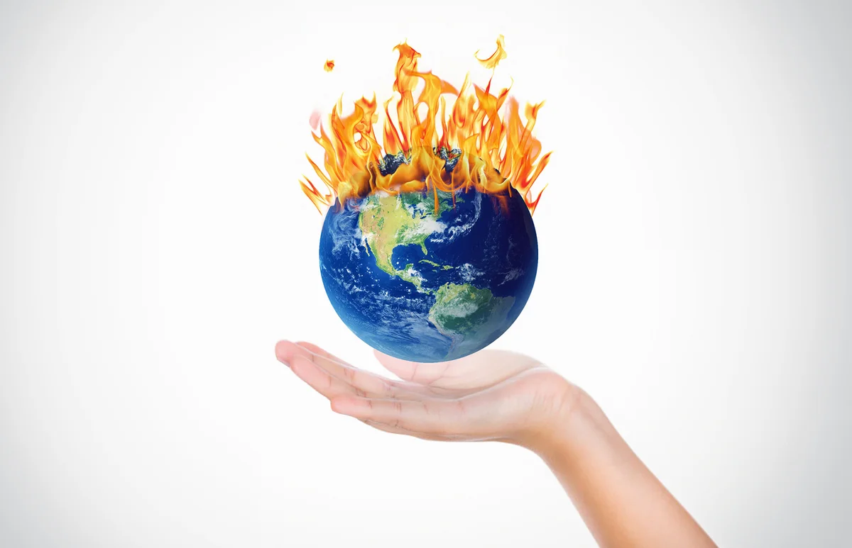Hands holding a globe on fire