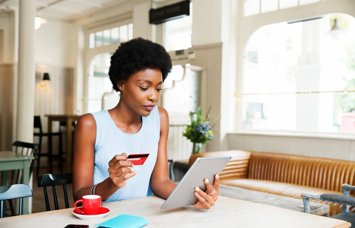 Woman with credit card and tablet