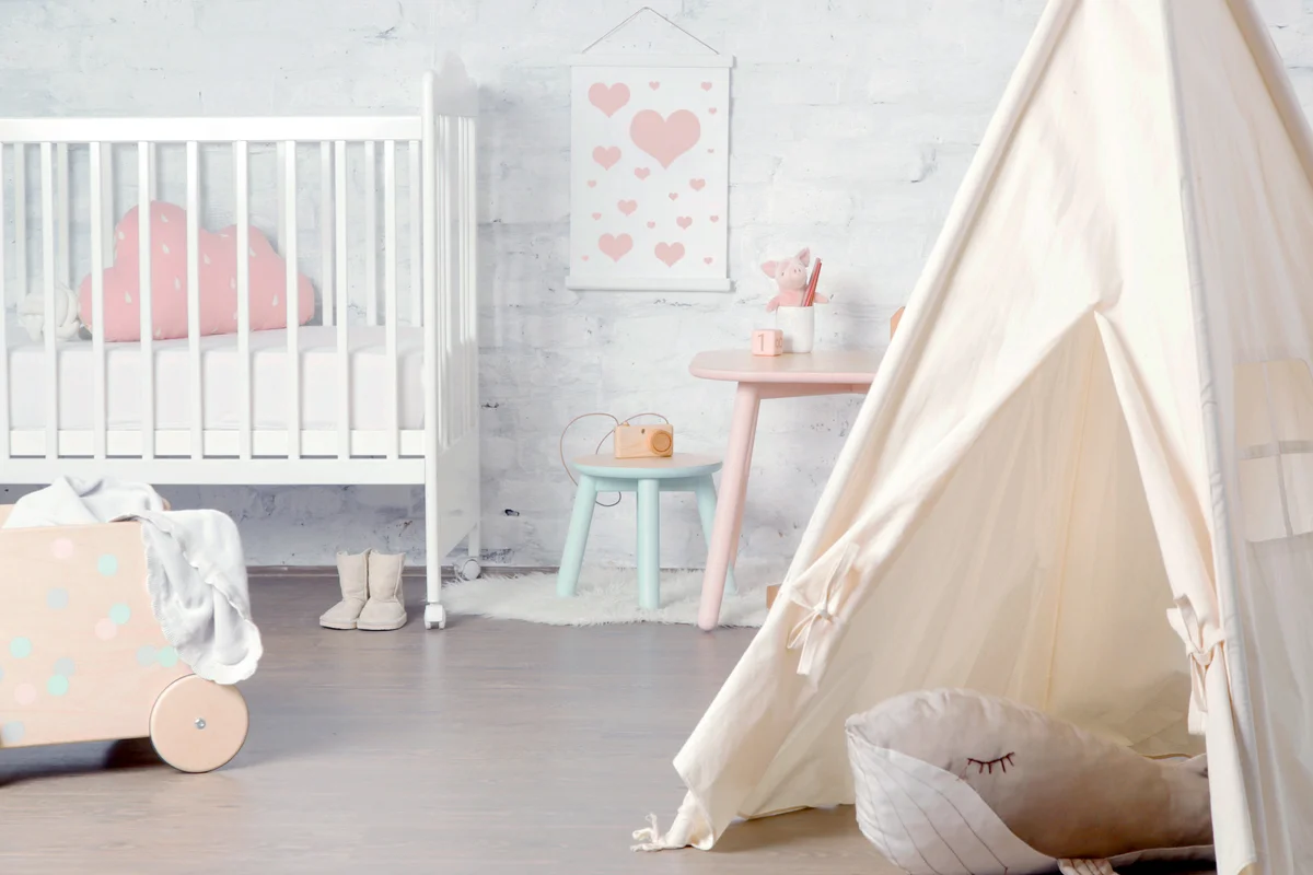 Tent, crib and kids furniture in the nursery room