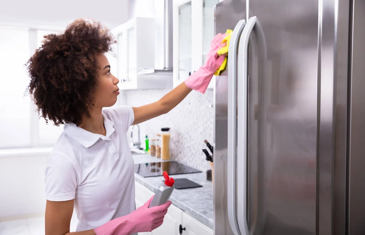 Young Woman Cleaning Refrigerator