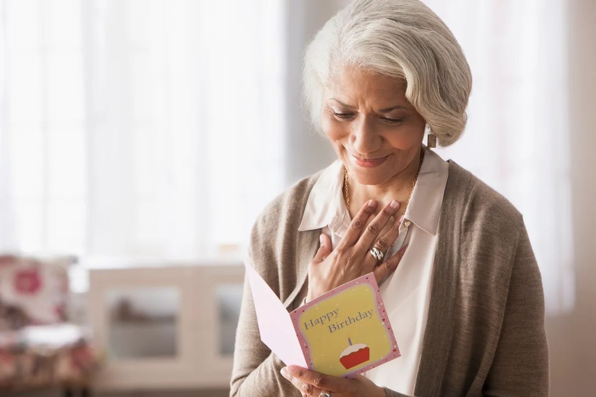 Woman reading vintage birthday card