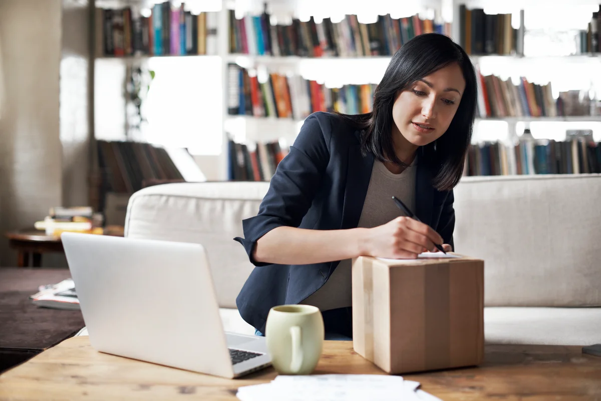 Woman writing on a box