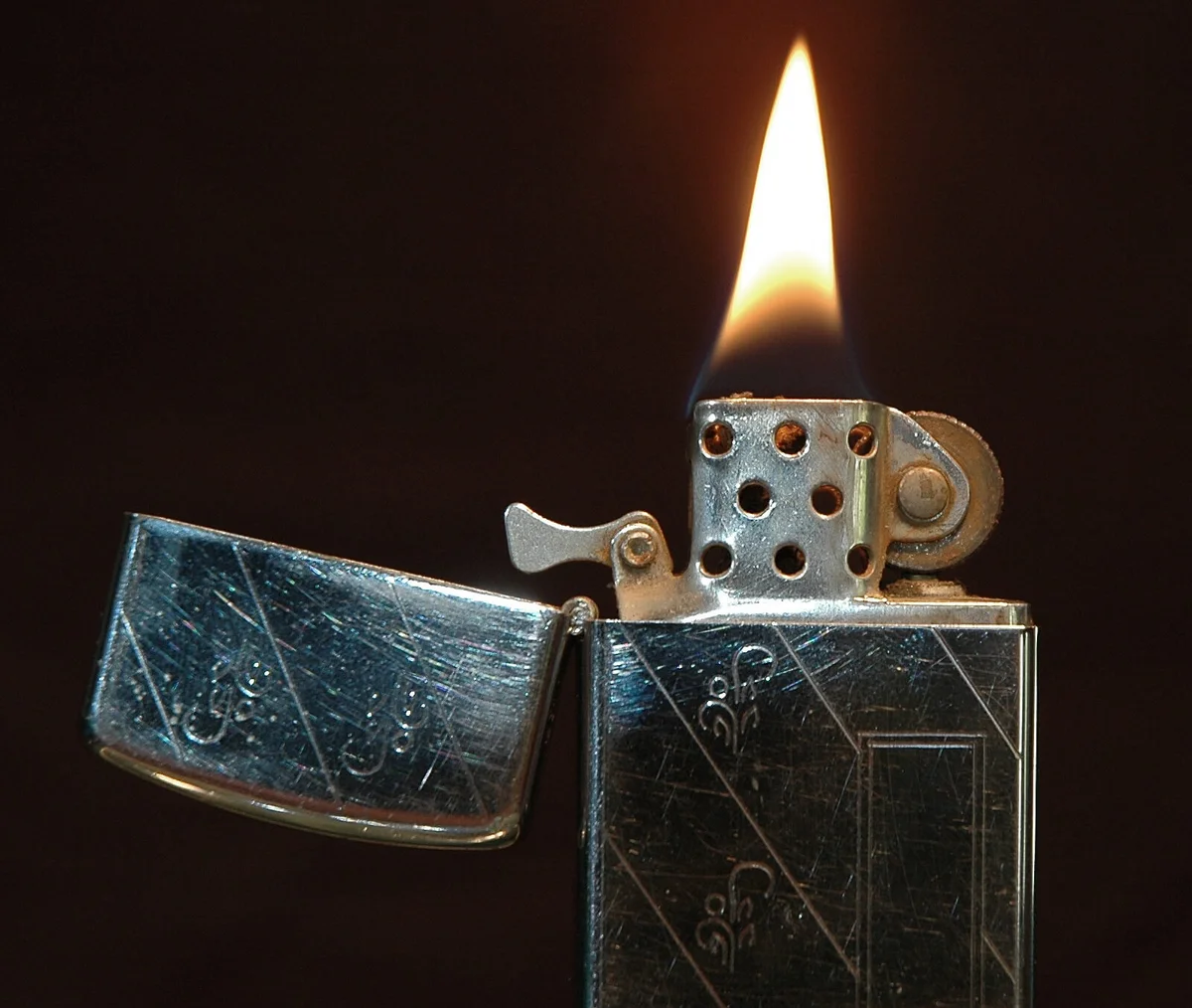 Close-up of a lit 1968 slim model Zippo lighter