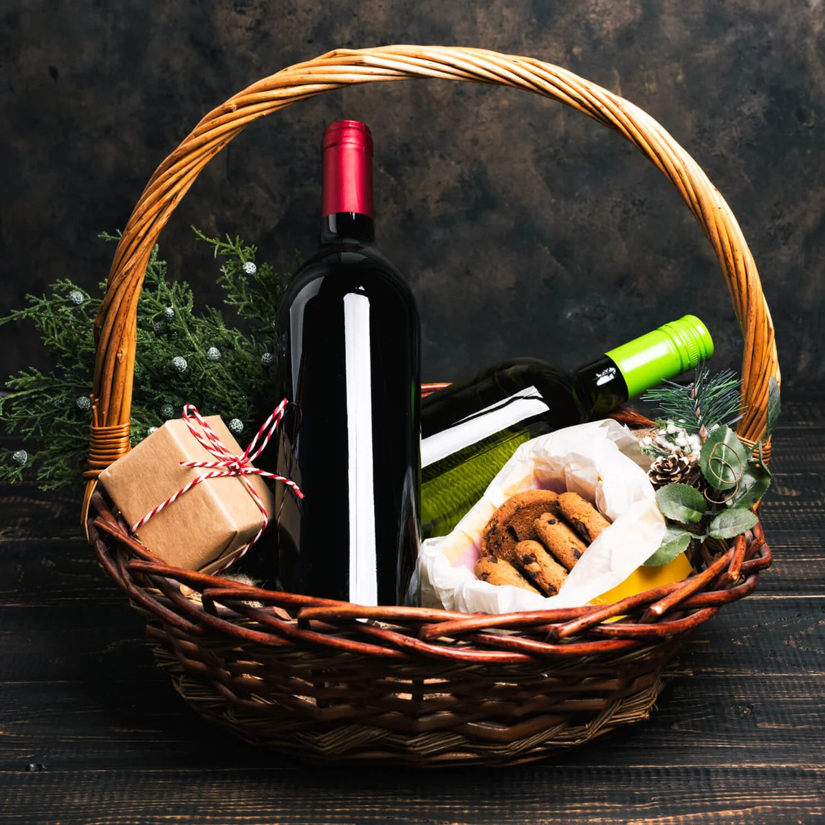 Bottles of red and white wine in Christmas basket