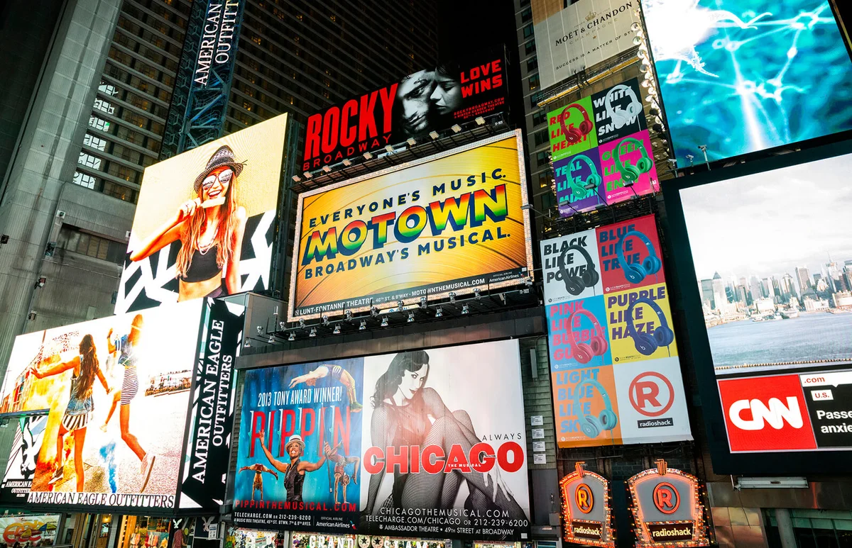 Broadway theater billboards in Times Square at night, New York