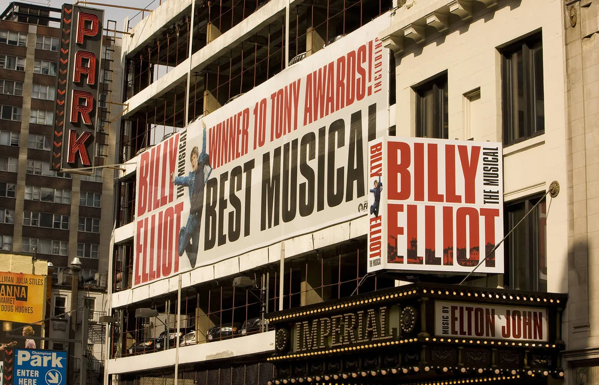 A large billboard promoting the "Billy Elliot" musical is seen on the side of a parking structure in this 2009 New York, NY | Getty Editorial Use