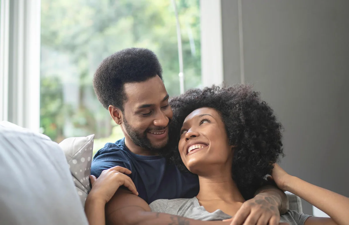 couple lying down and having romantic moment on couch