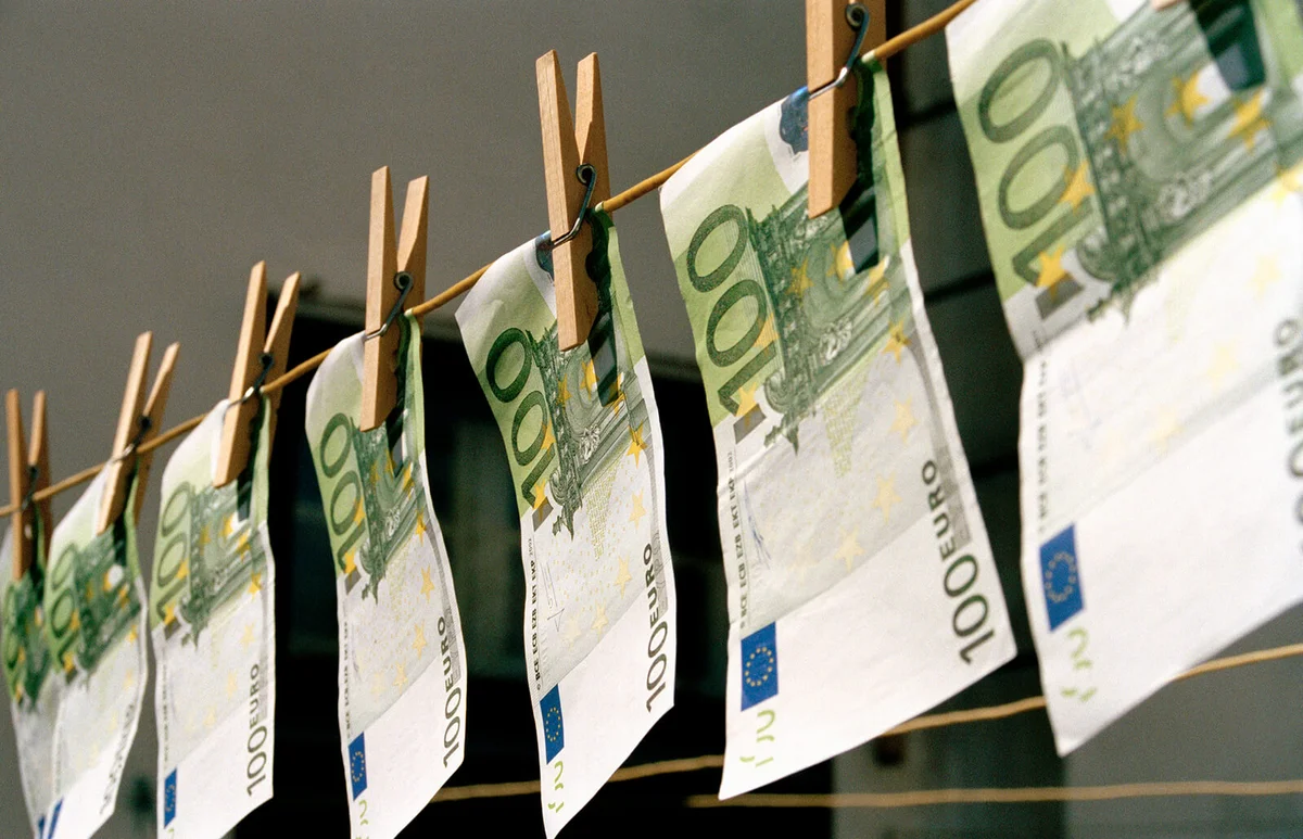 One Hundred Euro banknotes hanging on a washing line