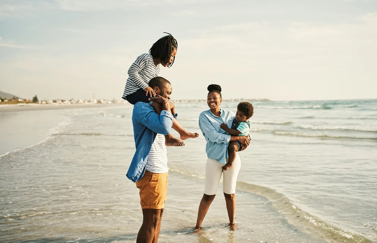 young family spending time together at the beach