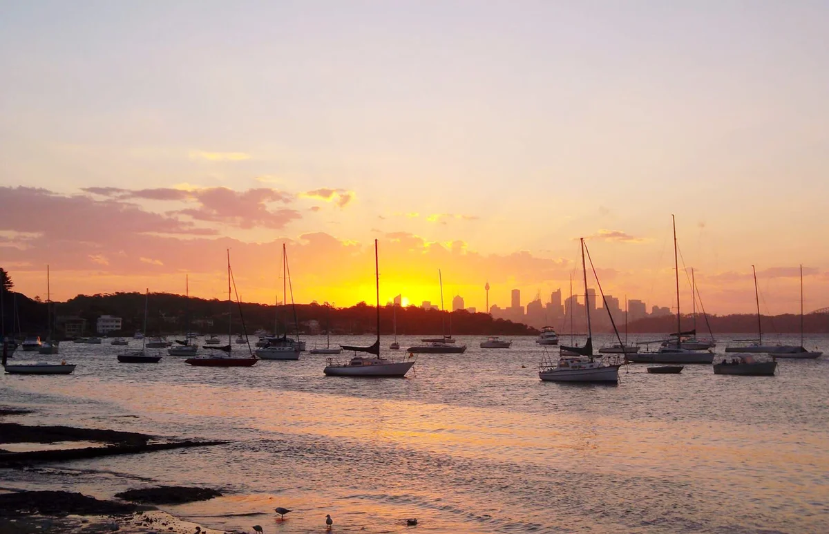 Boats In Sea During Sunset