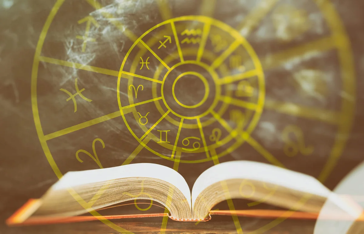 Zodiac signs set over an open book