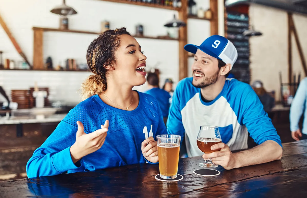 young man and woman having beers