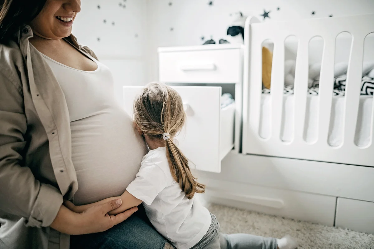 Pregnant mother and daughter waiting for baby