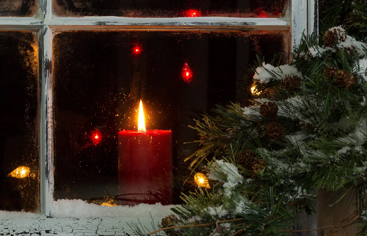Illuminated Candle Seen Through Glass