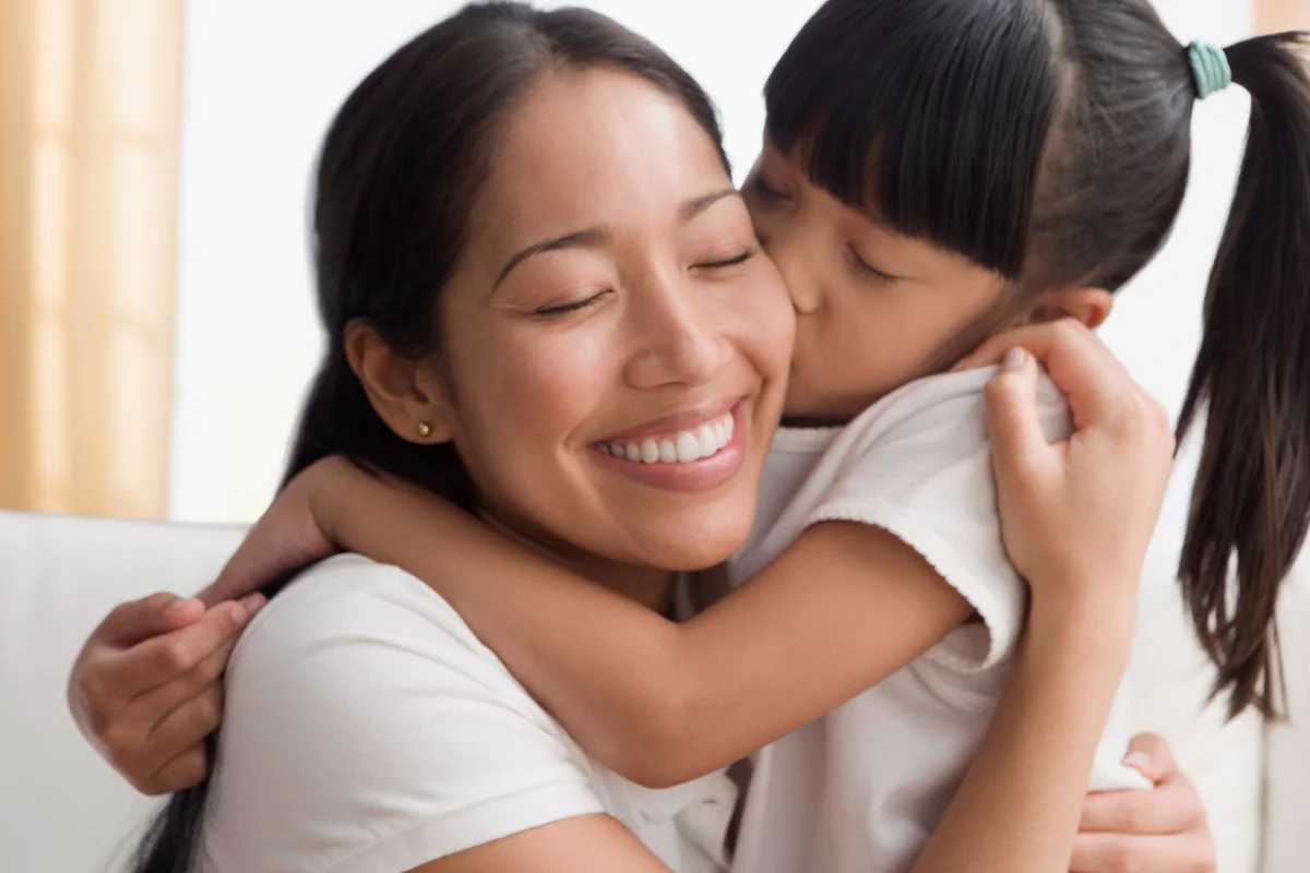 Mother and daughter hugging