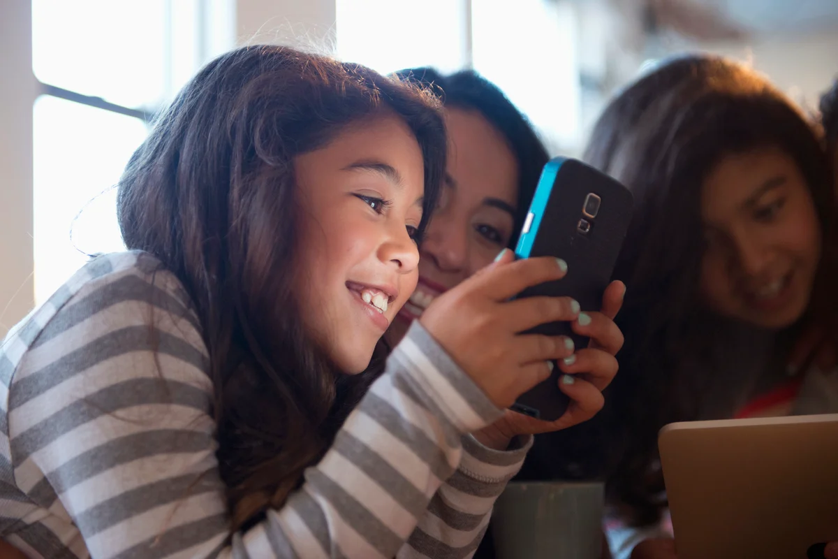 Mom and daughter using cell phone