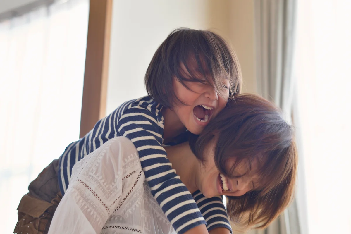 Mother giving daughter a piggyback ride