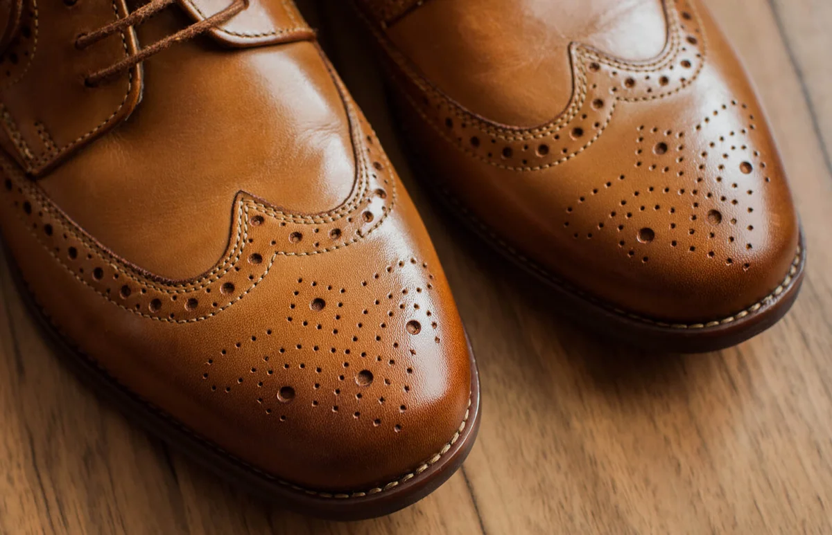 pair of brown derby shoes with full brogue