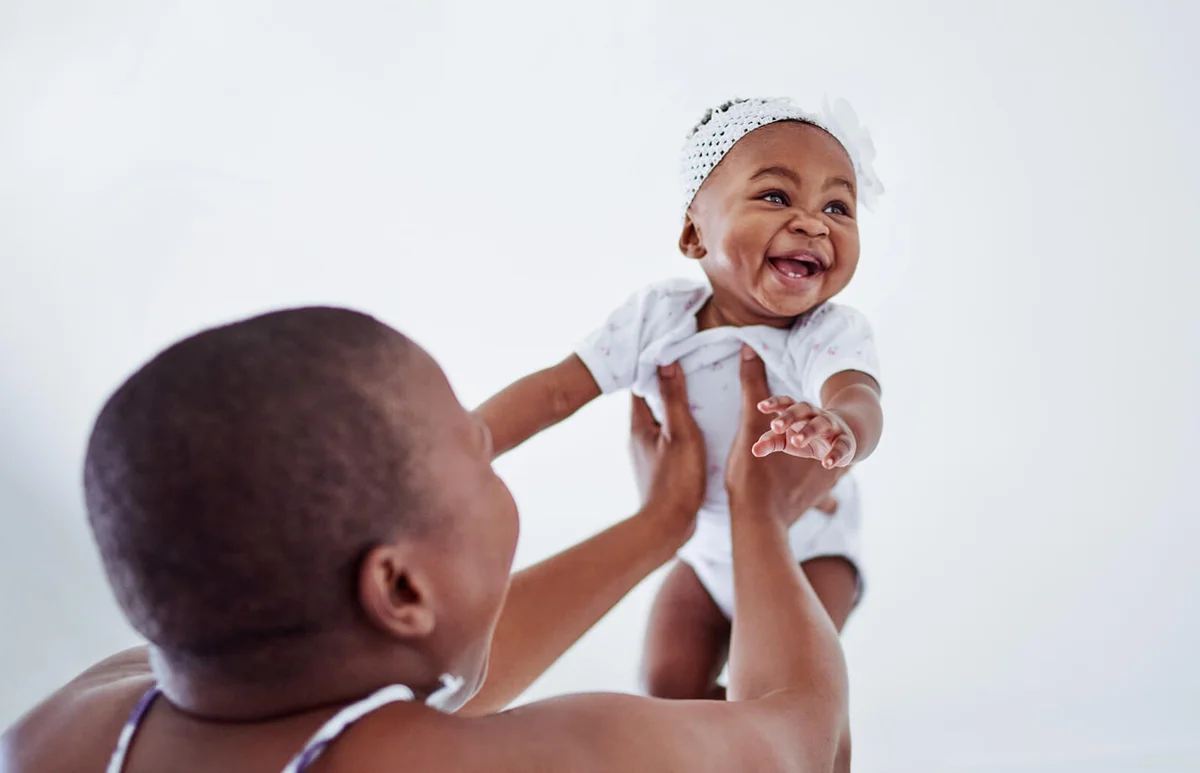 adorable baby girl bonding with her mother