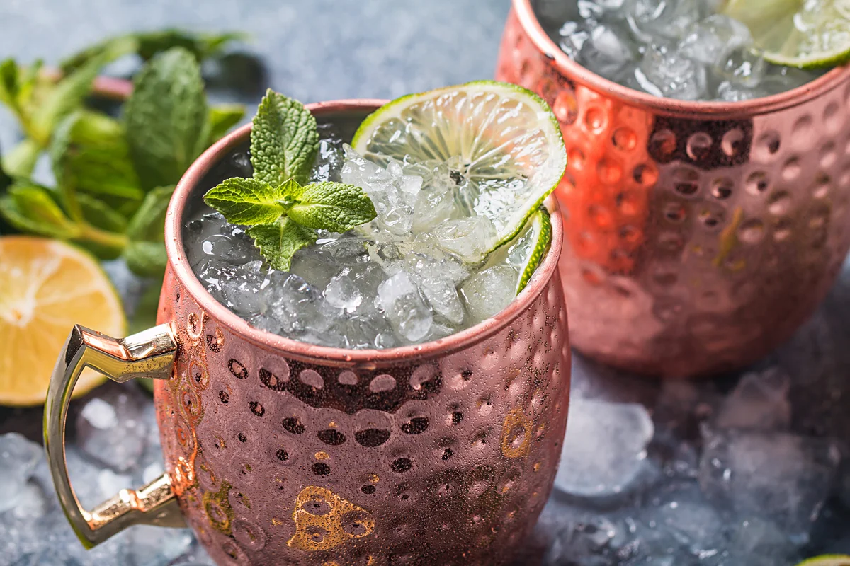 Moscow mule cocktail in copper cup with lime