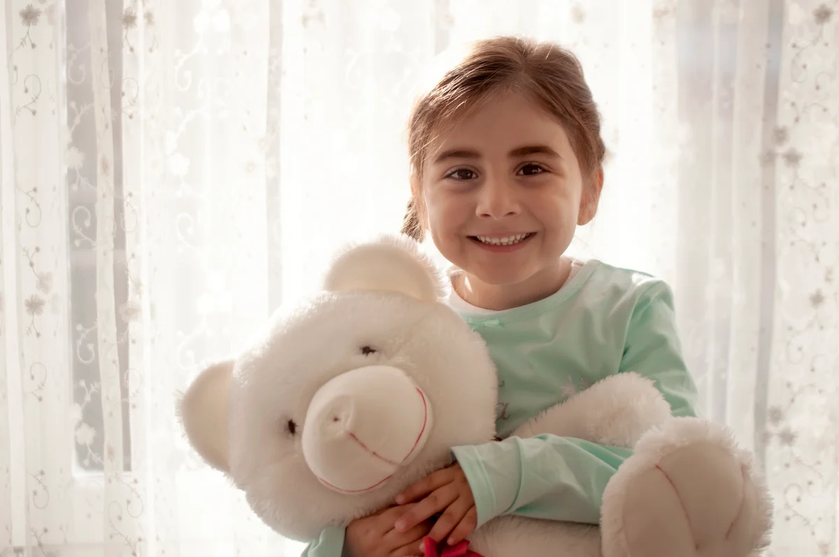 Cute girl loving her teddy bear