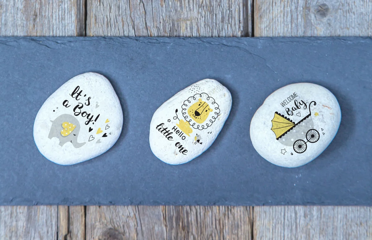 Three white stones elegantly arranged on a wooden and slate background