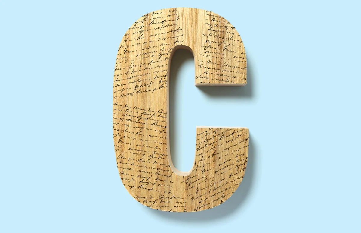 Letter C cut out from a piece of wood