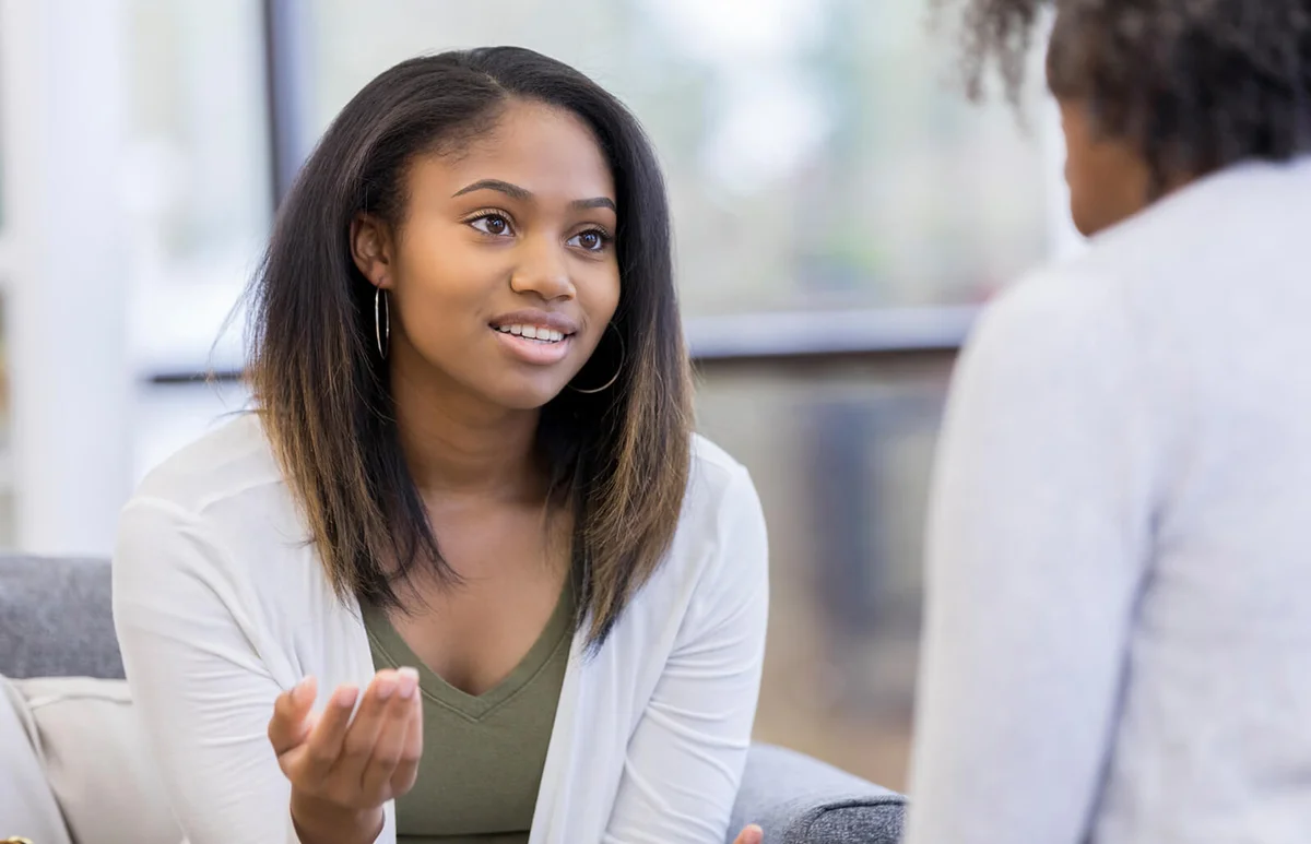 Teenage girl talks with parents