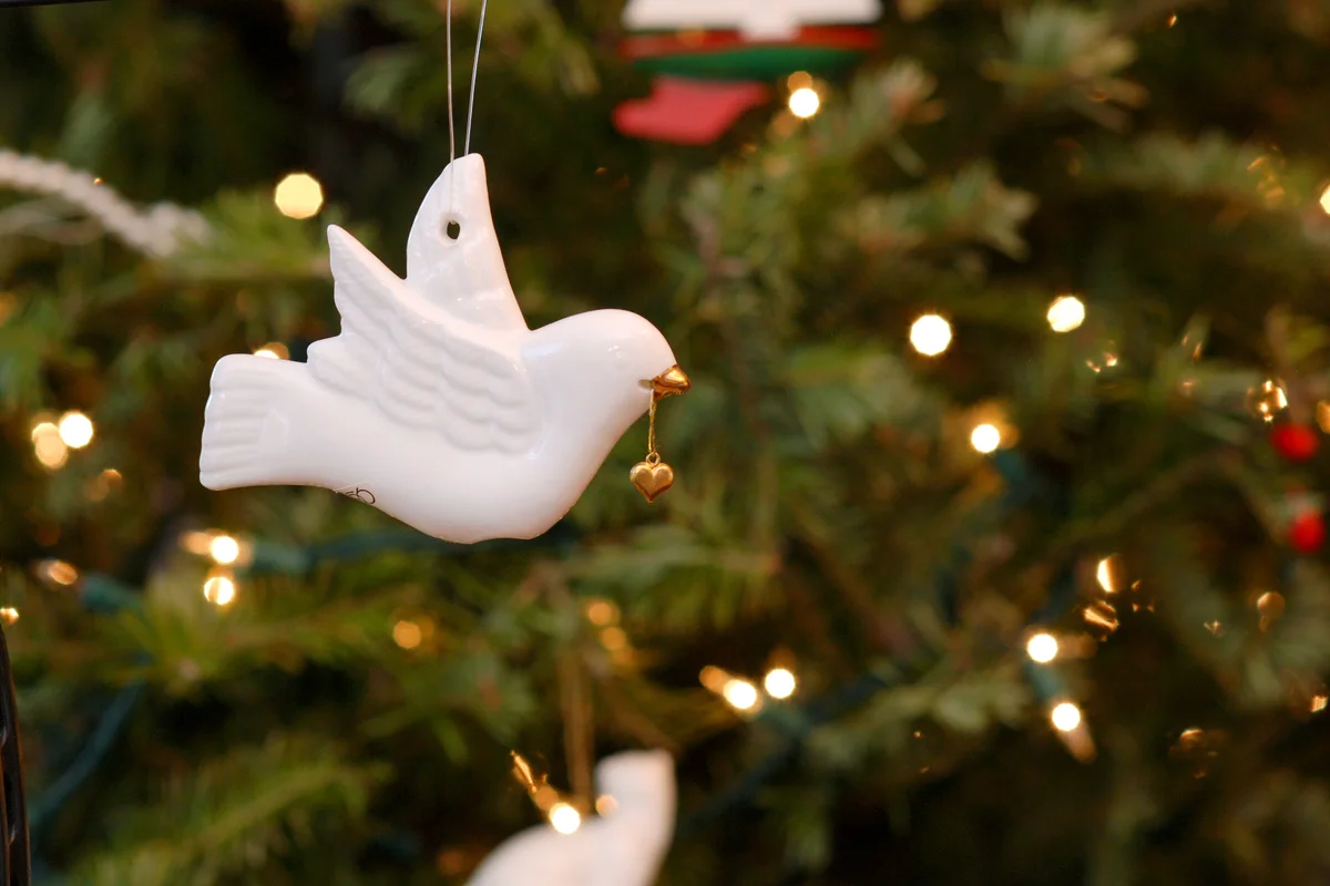 White dove ornament on a christmas tree