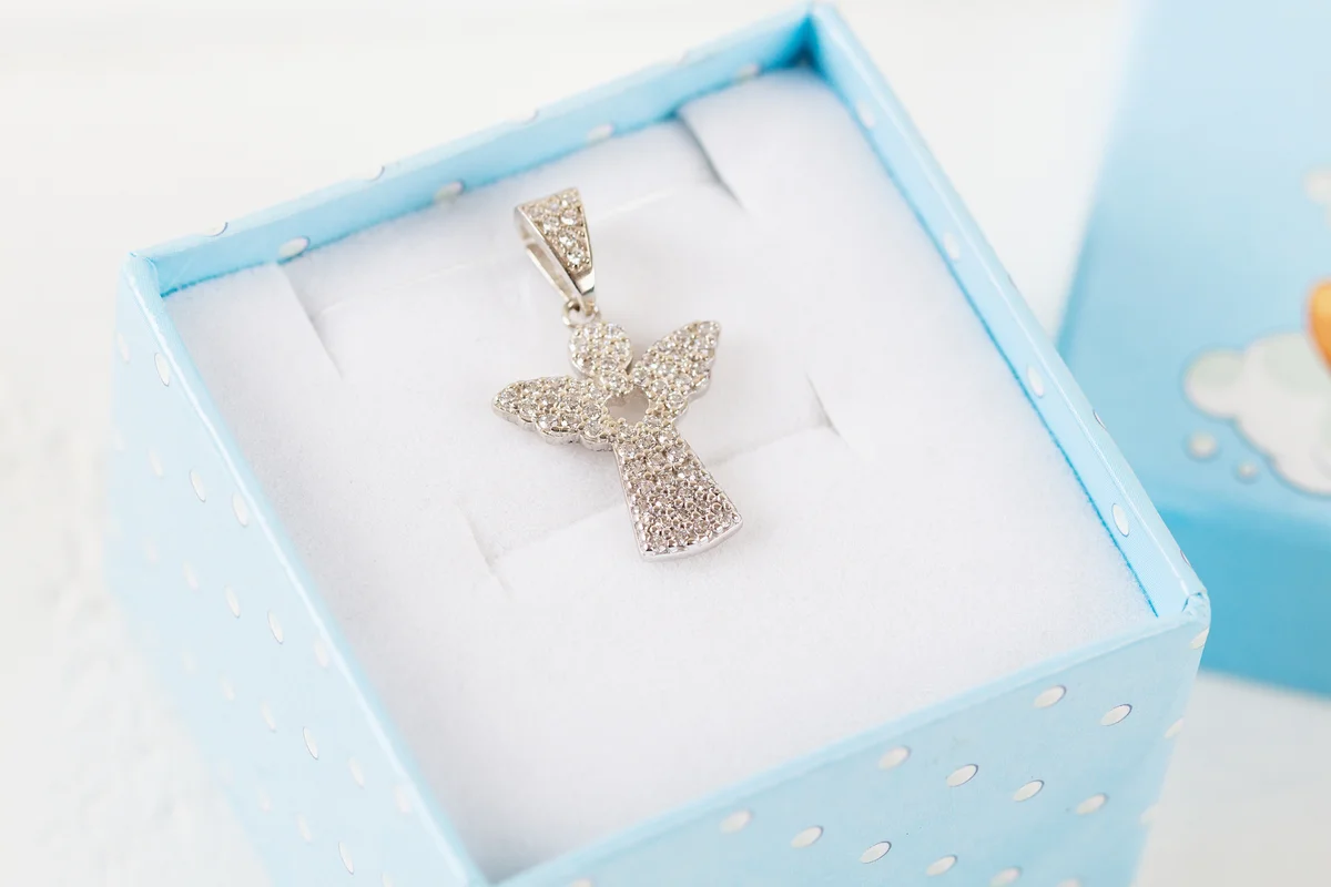 Silver pendant angel with diamonds in blue gift box.